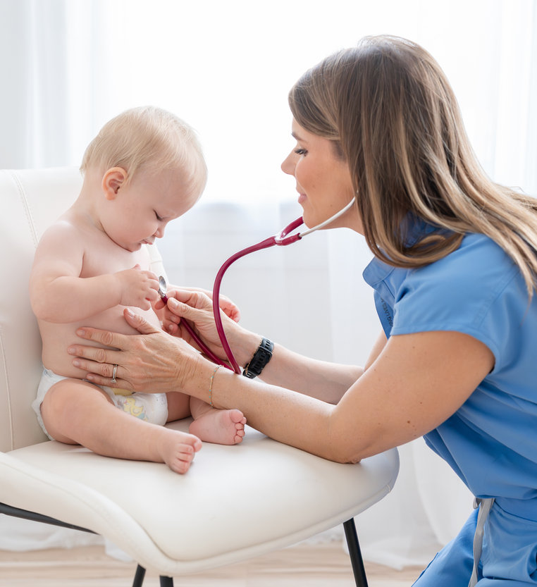 Dr. Lisa Hayes examining a young patient at Hayes Pediatrics